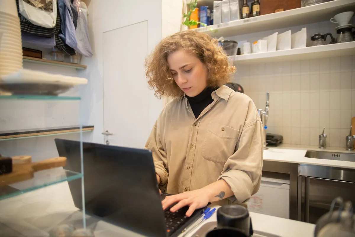 A small business owner building their own website on a laptop - the right call for validation-stage businesses