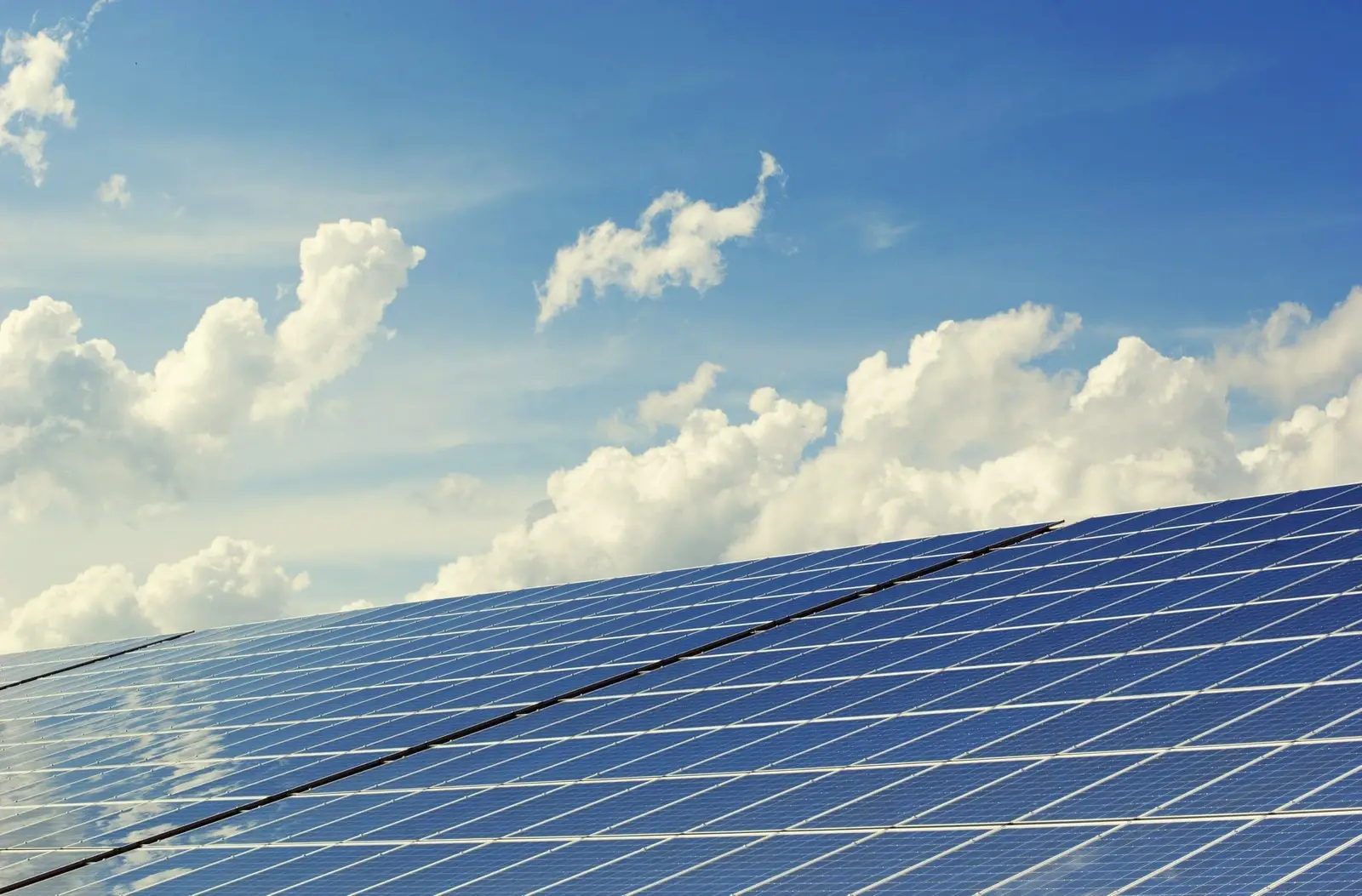 Sunrays Solar brand key visual — solar panels under a bright sky
